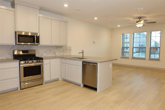 2538 Settlers Pl, Garland, TX 75042 - kitchen featuring stainless steel appliances, a sink, decorative backsplash, recessed lighting, and a peninsula