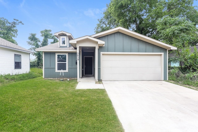 2829 Oakdale St, Dallas, TX 75215 - ranch-style home featuring a front lawn, driveway, an attached garage, and board and batten siding