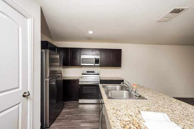 2829 Oakdale St, Dallas, TX 75215 - kitchen featuring appliances with stainless steel finishes, a sink, recessed lighting, dark wood-style floors, and dark brown cabinetry