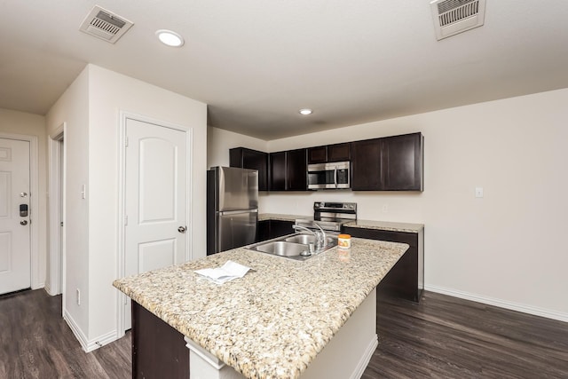 2829 Oakdale St, Dallas, TX 75215 - kitchen with appliances with stainless steel finishes, baseboards, dark wood-style flooring, a sink, and recessed lighting