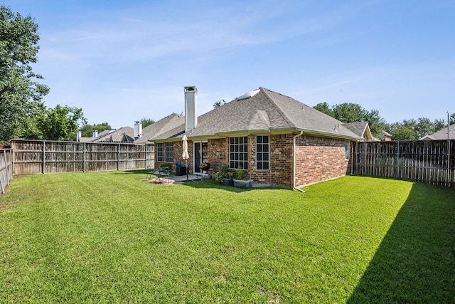 10119 Andre Dr, Irving, TX 75063 - back of house with brick siding, a shingled roof, a chimney, and a patio