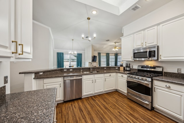 10119 Andre Dr, Irving, TX 75063 - kitchen featuring stainless steel appliances, a sink, a chandelier, white cabinetry, and dark wood finished floors