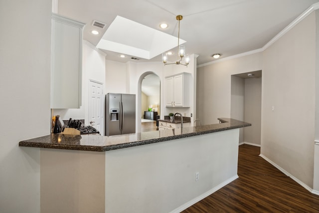 10119 Andre Dr, Irving, TX 75063 - kitchen with stainless steel fridge with ice dispenser, arched walkways, dark stone countertops, dark wood-style floors, and baseboards