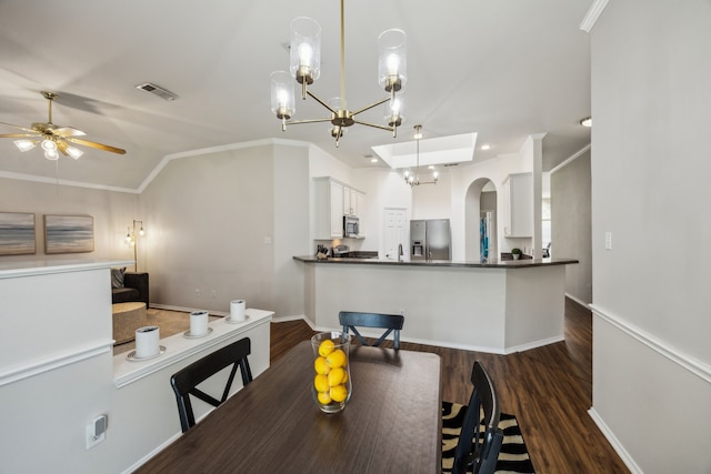 10119 Andre Dr, Irving, TX 75063 - dining space with ceiling fan, dark wood finished floors, arched walkways, a chandelier, and vaulted ceiling