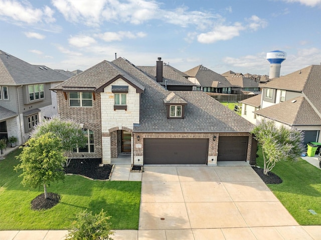 1417 Stoneleigh Pl, Aubrey, TX 76227 - view of front facade featuring brick siding, a residential view, driveway, a front yard, and an attached garage