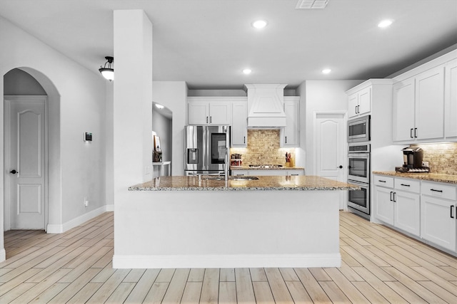 1417 Stoneleigh Pl, Aubrey, TX 76227 - kitchen with appliances with stainless steel finishes, custom range hood, a sink, tasteful backsplash, and light stone counters