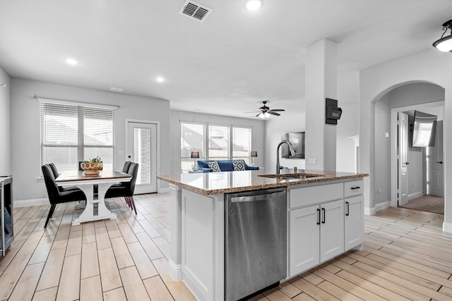 1417 Stoneleigh Pl, Aubrey, TX 76227 - kitchen featuring stainless steel dishwasher, a sink, light wood-style flooring, baseboards, and light stone counters