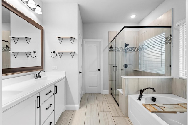 1417 Stoneleigh Pl, Aubrey, TX 76227 - bathroom with a bath, a shower stall, double vanity, baseboards, and recessed lighting