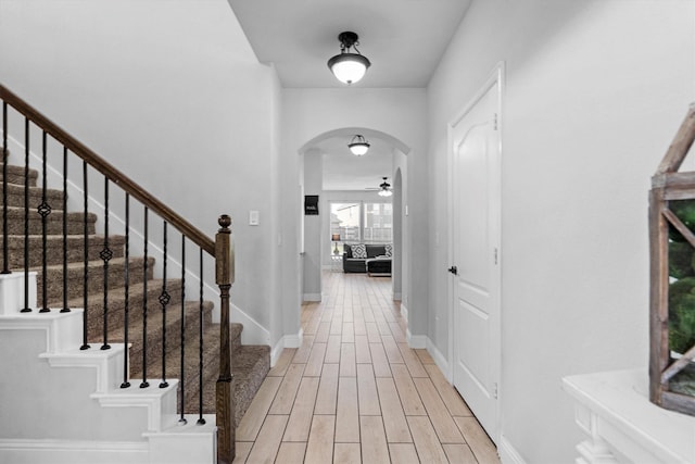 1417 Stoneleigh Pl, Aubrey, TX 76227 - entrance foyer with arched walkways, a ceiling fan, light wood-style floors, and stairway