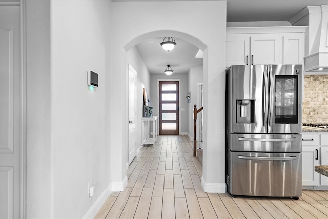 1417 Stoneleigh Pl, Aubrey, TX 76227 - kitchen with appliances with stainless steel finishes, backsplash, arched walkways, custom exhaust hood, and white cabinets