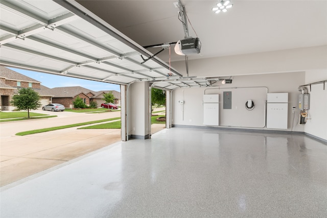 1616 Berry Ridge Trl, Aubrey, TX 76227 - garage with electric panel, freestanding refrigerator, baseboards, and a garage door opener