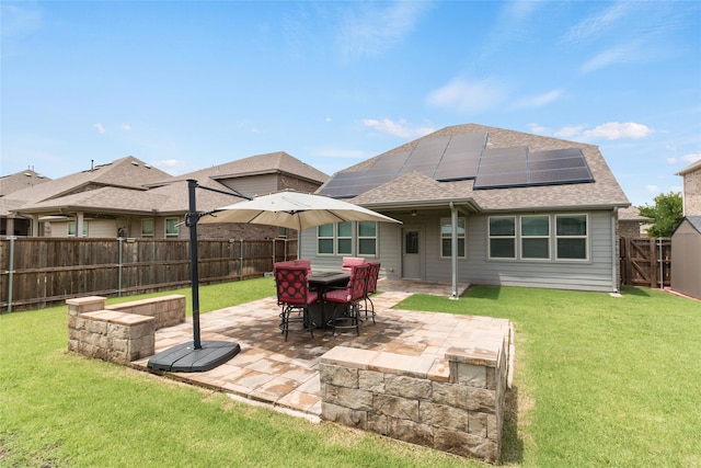 1616 Berry Ridge Trl, Aubrey, TX 76227 - back of property with roof with shingles, solar panels, and a patio area
