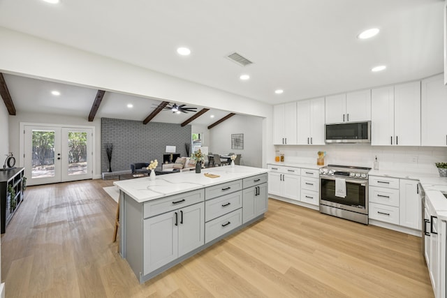 37 Devonshire Dr, Bedford, TX 76021 - kitchen with appliances with stainless steel finishes, open floor plan, gray cabinets, ceiling fan, and a kitchen island