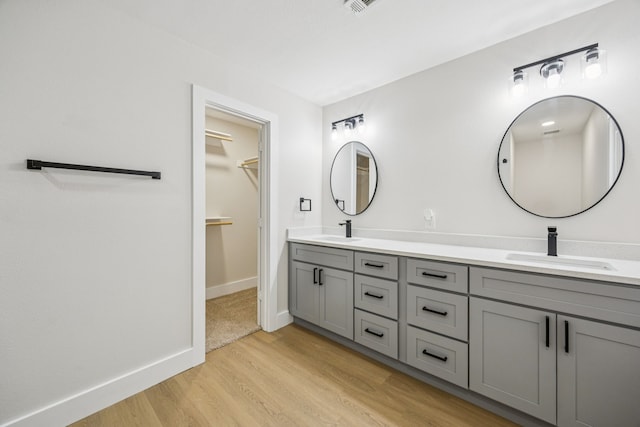 37 Devonshire Dr, Bedford, TX 76021 - full bath with double vanity, wood finished floors, a spacious closet, and baseboards
