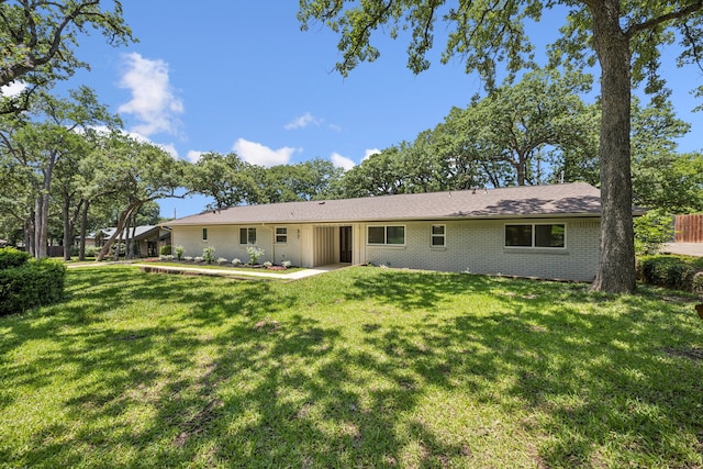 37 Devonshire Dr, Bedford, TX 76021 - rear view of house featuring brick siding and a yard