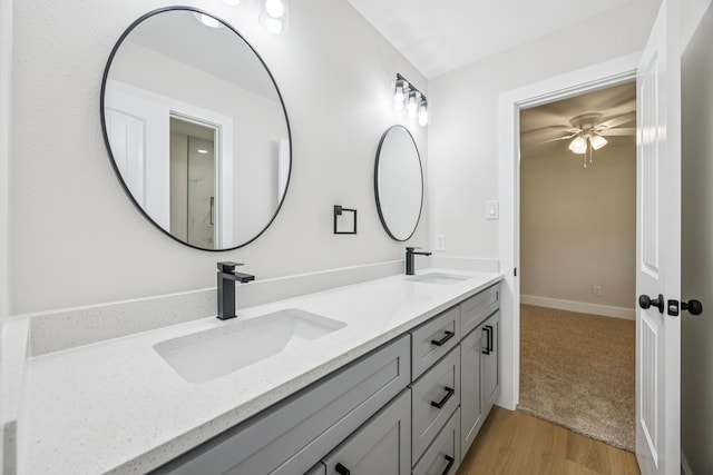 37 Devonshire Dr, Bedford, TX 76021 - bathroom with double vanity, wood finished floors, and a ceiling fan