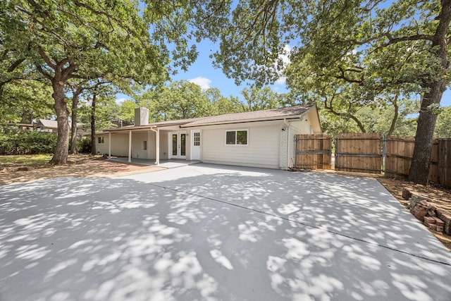 37 Devonshire Dr, Bedford, TX 76021 - rear view of property with french doors, a chimney, a patio, and a gate