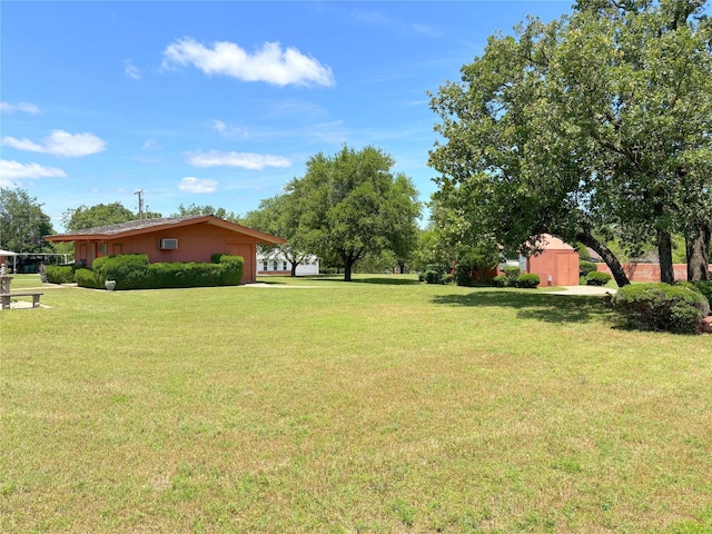 905 Bennett Dr, Bowie, TX 76230 - view of green lawn with a garage and an outbuilding