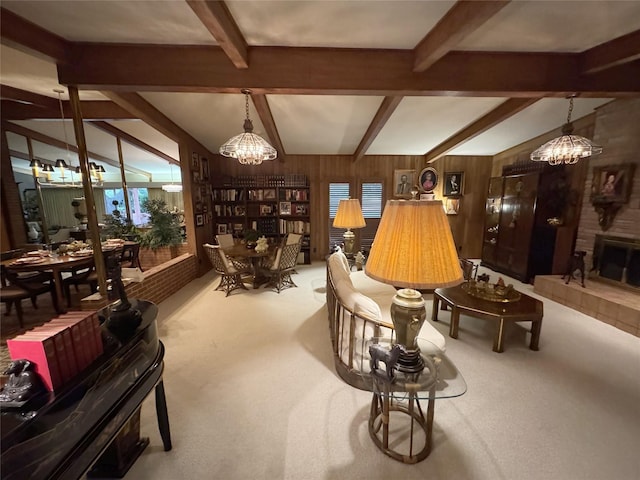 905 Bennett Dr, Bowie, TX 76230 - living area with a chandelier, beam ceiling, wooden walls, light colored carpet, and a fireplace
