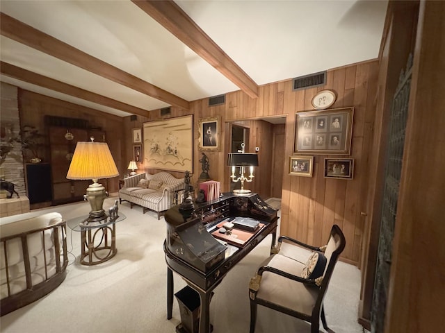 905 Bennett Dr, Bowie, TX 76230 - living room with wood walls, carpet, and beam ceiling