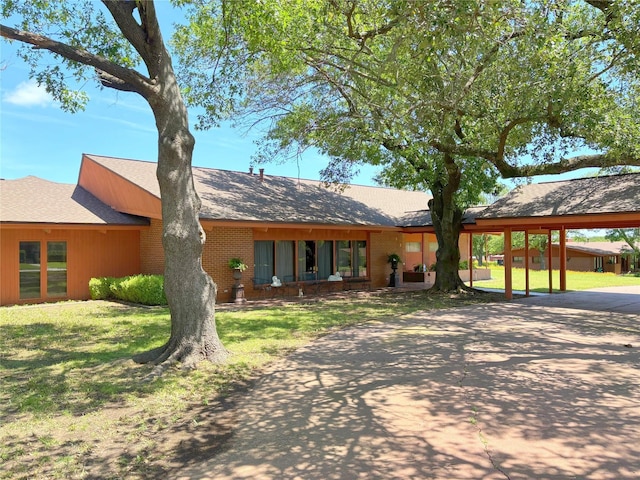 905 Bennett Dr, Bowie, TX 76230 - view of front of home with a front lawn, concrete driveway, a carport, and brick siding