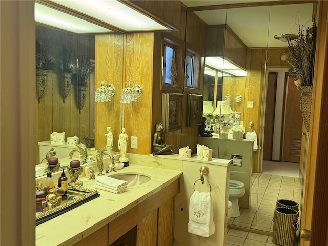 905 Bennett Dr, Bowie, TX 76230 - bathroom with tile patterned flooring, toilet, vanity, wooden walls, and a bidet