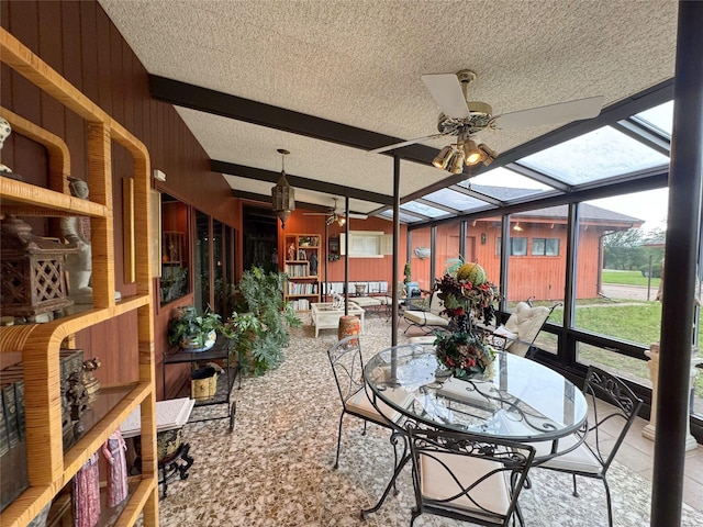 905 Bennett Dr, Bowie, TX 76230 - sunroom featuring ceiling fan, beamed ceiling, and outdoor dining area