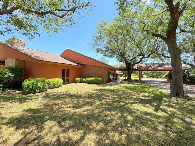 905 Bennett Dr, Bowie, TX 76230 - view of grassy yard featuring a carport