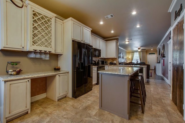 1461 Bristol Ln, Providence Village, TX 76227 - kitchen with black appliances, recessed lighting, a peninsula, a kitchen island, and baseboards