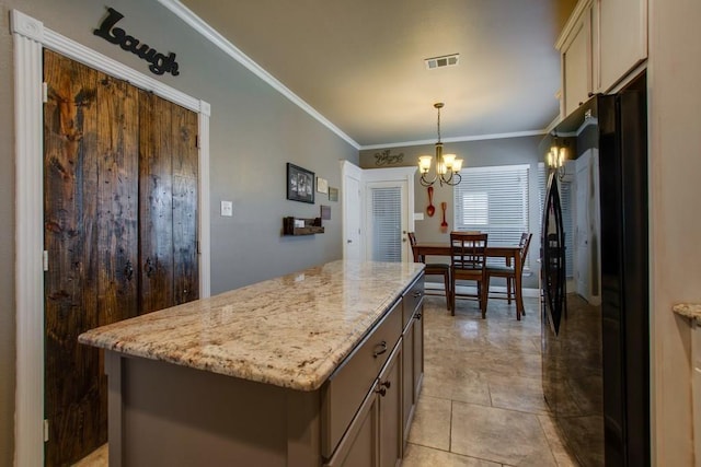 1461 Bristol Ln, Providence Village, TX 76227 - kitchen featuring freestanding refrigerator, crown molding, a kitchen island, a chandelier, and light stone countertops