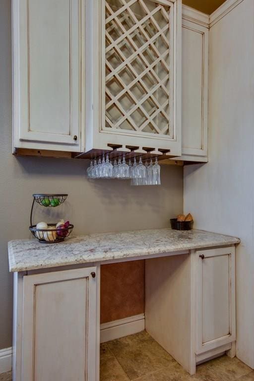 1461 Bristol Ln, Providence Village, TX 76227 - indoor dry bar with light tile patterned flooring, built in study area, and baseboards