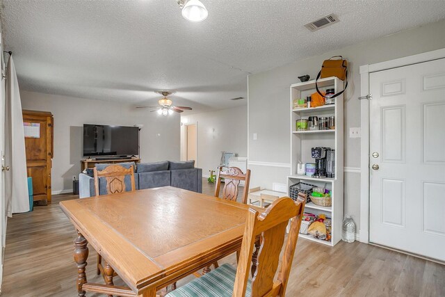 423 Parkview Dr, Burleson, TX 76028 - dining space with a textured ceiling, light wood-type flooring, and ceiling fan