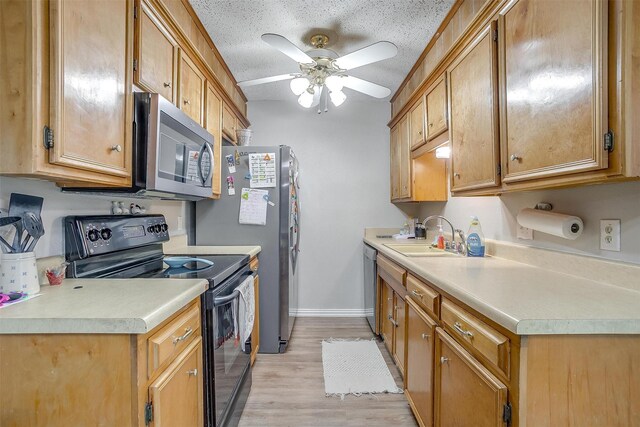 423 Parkview Dr, Burleson, TX 76028 - kitchen with stainless steel appliances, a sink, light countertops, ceiling fan, and light wood-style floors