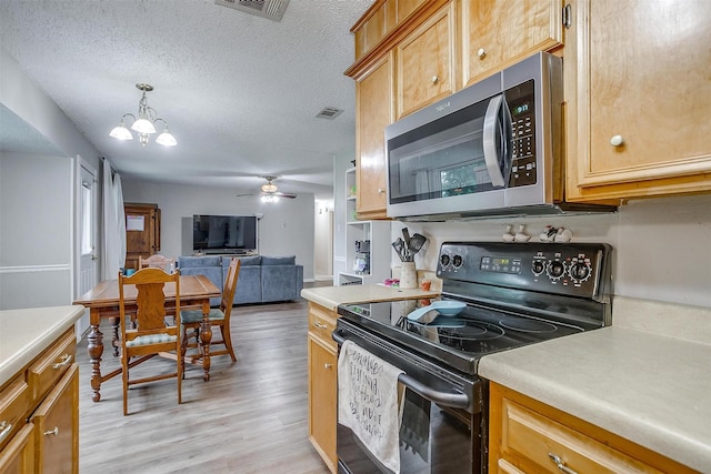 423 Parkview Dr, Burleson, TX 76028 - kitchen featuring black electric range, stainless steel microwave, light countertops, light wood-style flooring, and open floor plan