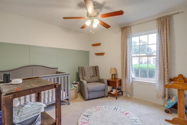 423 Parkview Dr, Burleson, TX 76028 - bedroom featuring carpet, a textured ceiling, a nursery area, and ceiling fan