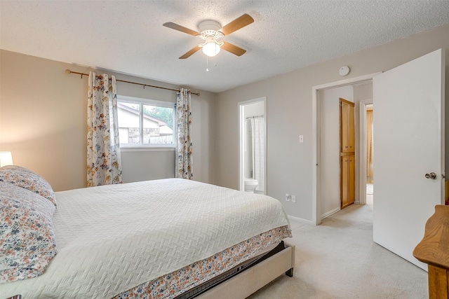 423 Parkview Dr, Burleson, TX 76028 - bedroom featuring light carpet, ensuite bathroom, ceiling fan, baseboards, and a textured ceiling