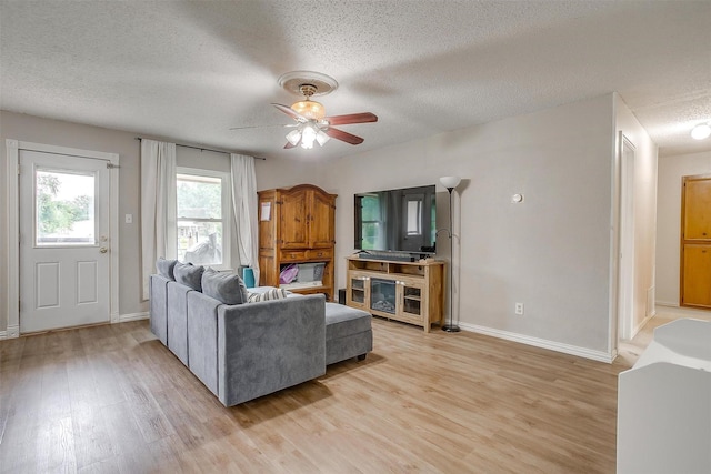 423 Parkview Dr, Burleson, TX 76028 - living area featuring a textured ceiling, light wood-style floors, ceiling fan, and baseboards