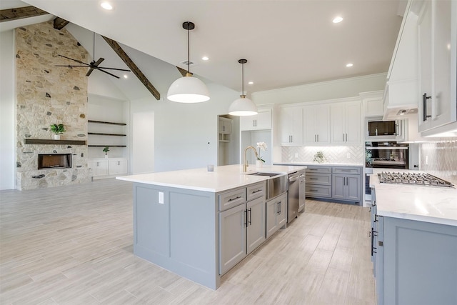 823 Wind River Pass, Azle, TX 76020 - kitchen featuring a sink, gray cabinets, stainless steel appliances, open floor plan, and light countertops