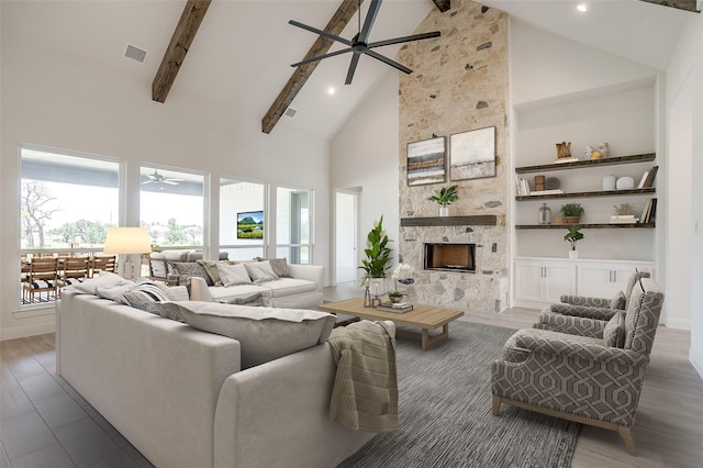 823 Wind River Pass, Azle, TX 76020 - living room with ceiling fan, high vaulted ceiling, beam ceiling, a fireplace, and wood finished floors