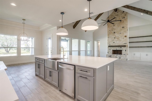 823 Wind River Pass, Azle, TX 76020 - kitchen featuring stainless steel dishwasher, gray cabinetry, a sink, light countertops, and open floor plan