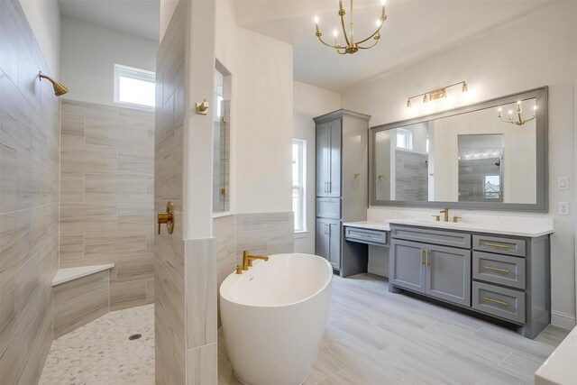 823 Wind River Pass, Azle, TX 76020 - full bathroom featuring a walk in shower, a soaking tub, a chandelier, and vanity
