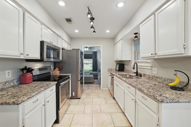 6701 Ridgetop Rd, North Richland Hills, TX 76182 - kitchen featuring appliances with stainless steel finishes, recessed lighting, white cabinets, and light stone countertops