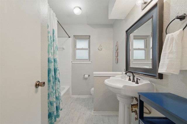 6701 Ridgetop Rd, North Richland Hills, TX 76182 - bathroom featuring wood finished floors and shower / tub combo