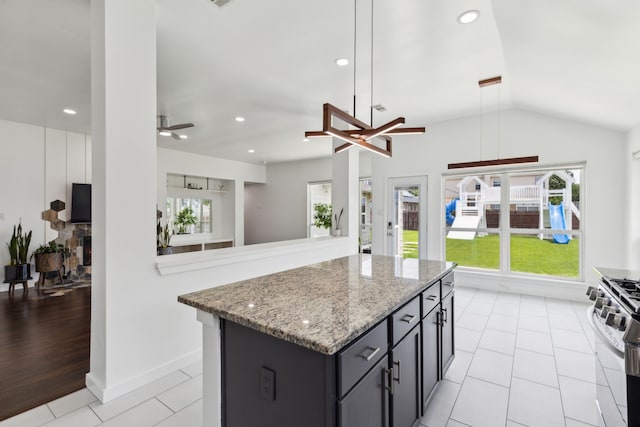 826 Ashley Pl, Mesquite, TX 75181 - kitchen featuring stainless steel gas range, ceiling fan, a kitchen island, light stone counters, and recessed lighting