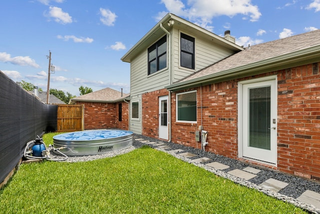 826 Ashley Pl, Mesquite, TX 75181 - back of property with brick siding, a chimney, roof with shingles, and a pool
