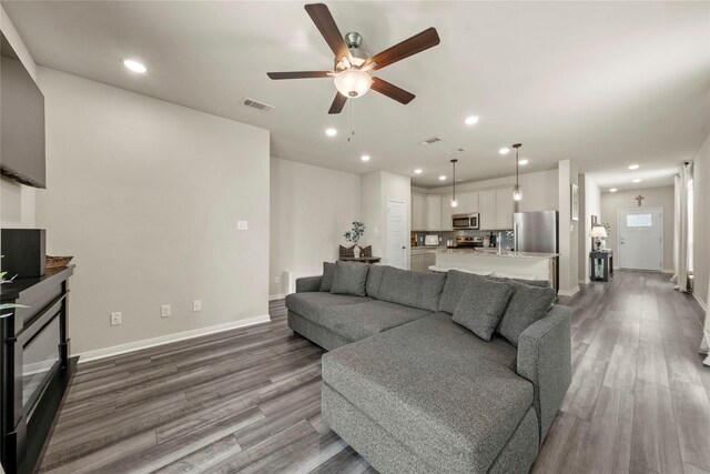 1512 Elise Ave, Waco, TX 76706 - living area with wood finished floors, ceiling fan, baseboards, recessed lighting, and a fireplace