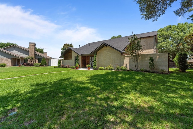 1617 Versailles Dr, Richardson, TX 75081 - view of front of house with a front yard and brick siding