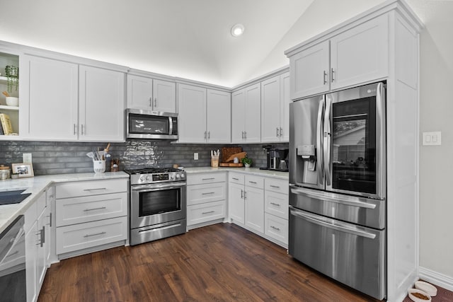 1617 Versailles Dr, Richardson, TX 75081 - kitchen with appliances with stainless steel finishes, decorative backsplash, vaulted ceiling, light stone countertops, and dark wood-style floors