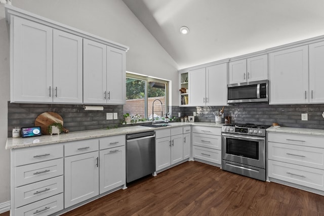 1617 Versailles Dr, Richardson, TX 75081 - kitchen with stainless steel appliances, a sink, vaulted ceiling, backsplash, and white cabinets