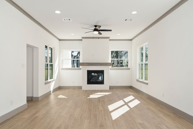 840 Northwood Rd, Fort Worth, TX 76107 - unfurnished living room featuring ornamental molding, a glass covered fireplace, baseboards, a ceiling fan, and light wood-type flooring